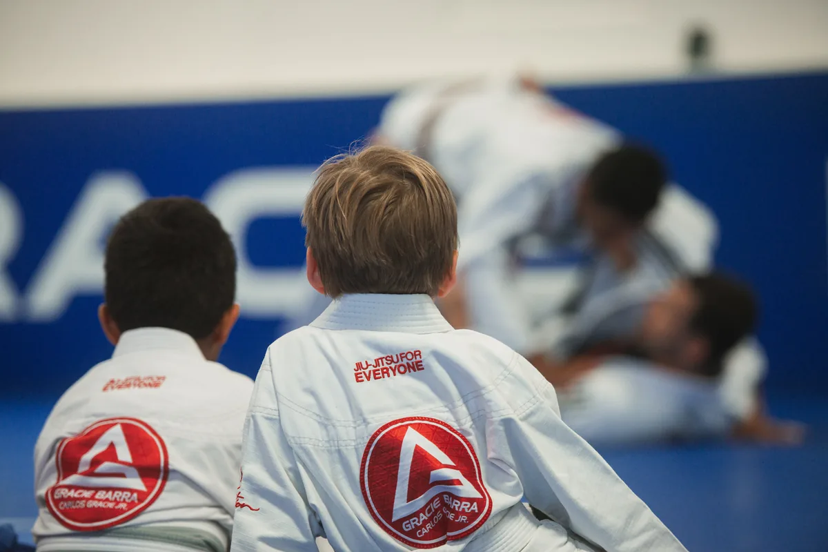 Two children watching a Jiu-Jitsu session together