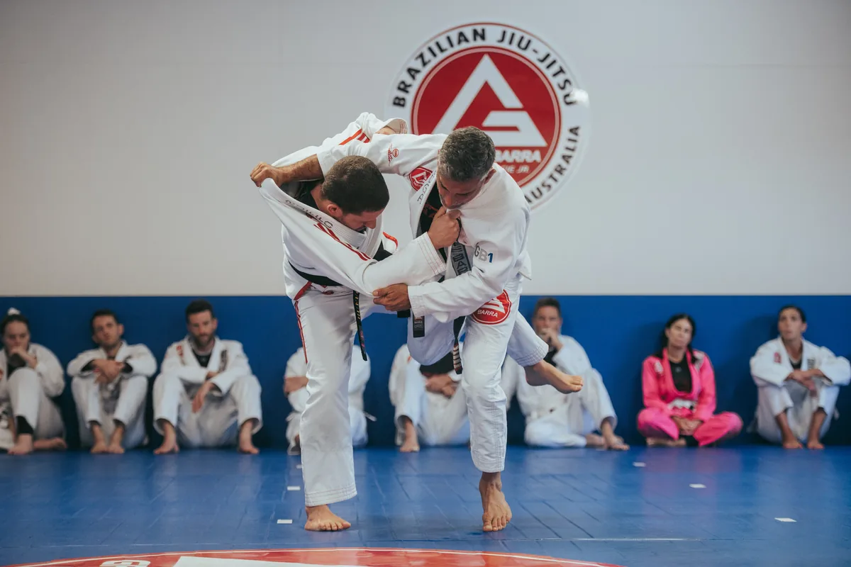 Two black belt coaches demonstrating a Jiu-Jitsu technique
